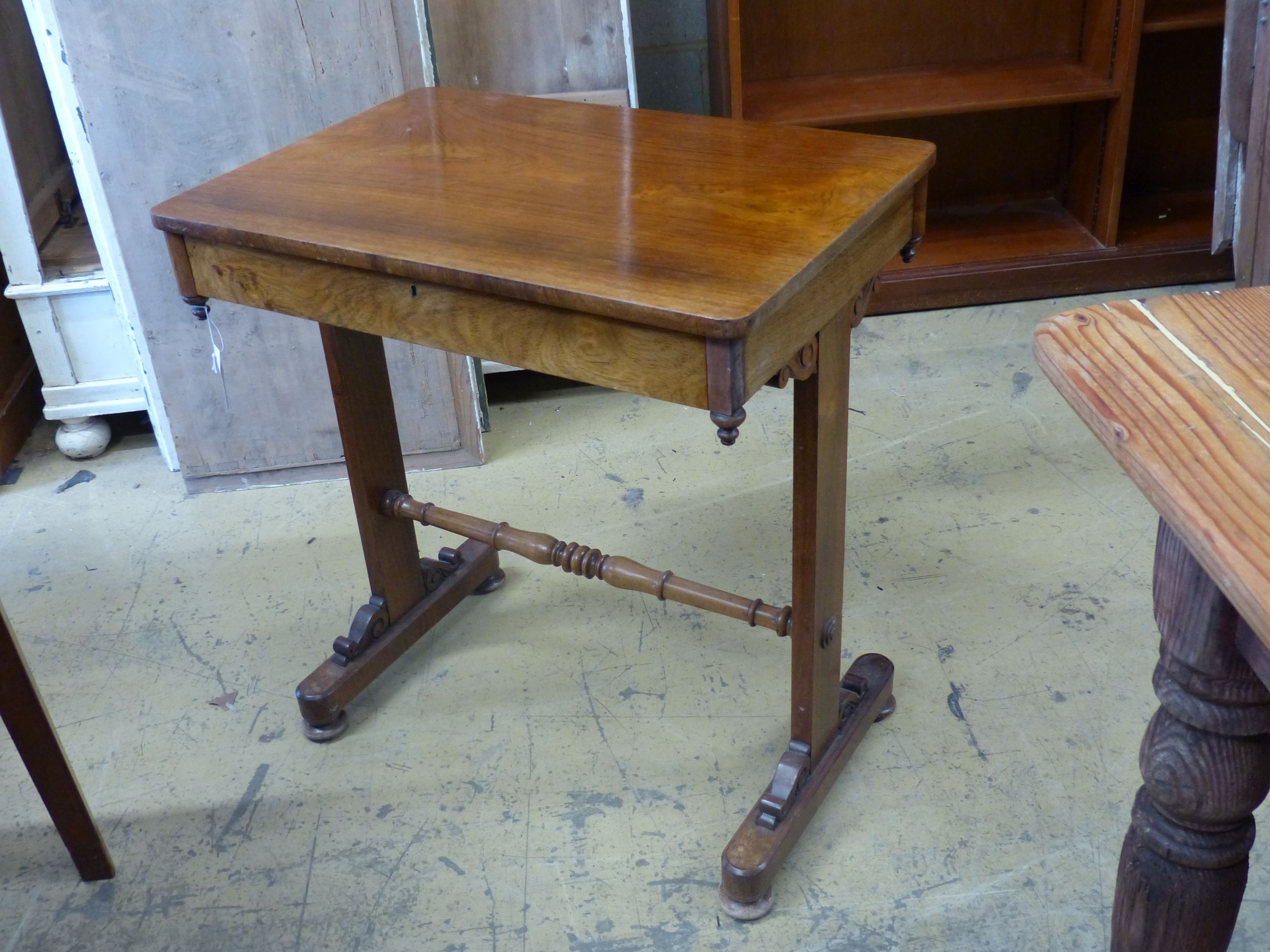 A Victorian rosewood side table, on end standard supports, width 66cm, depth 45cm, height 72cm